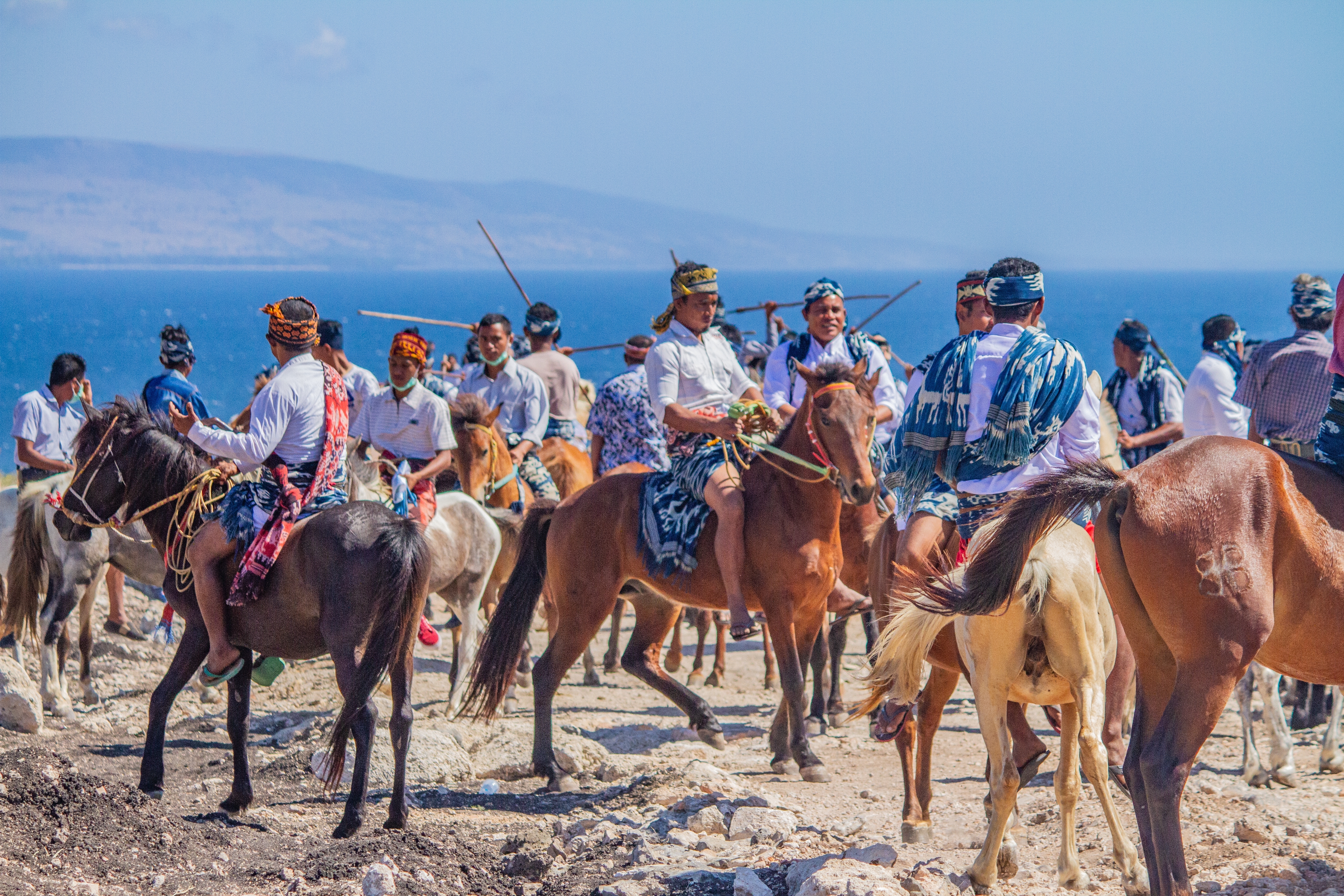 Sumbanese rider at full gallop holding a spear during the Pasola festival