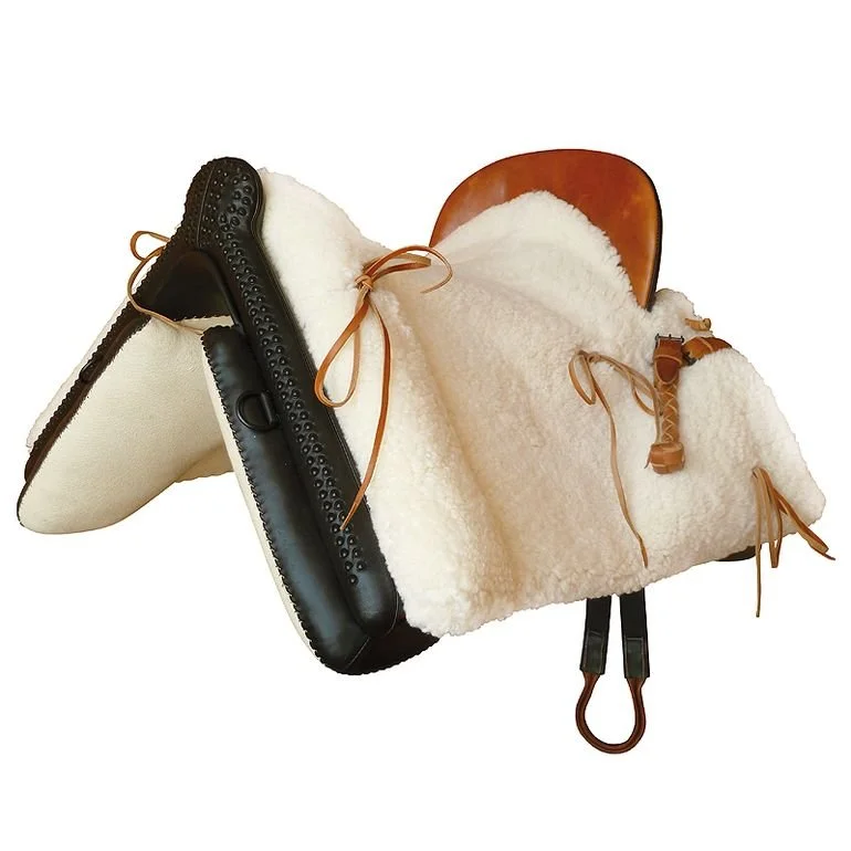 Traditional Silla Vaquera — working saddle with sheepskin padding and wooden saddle tree